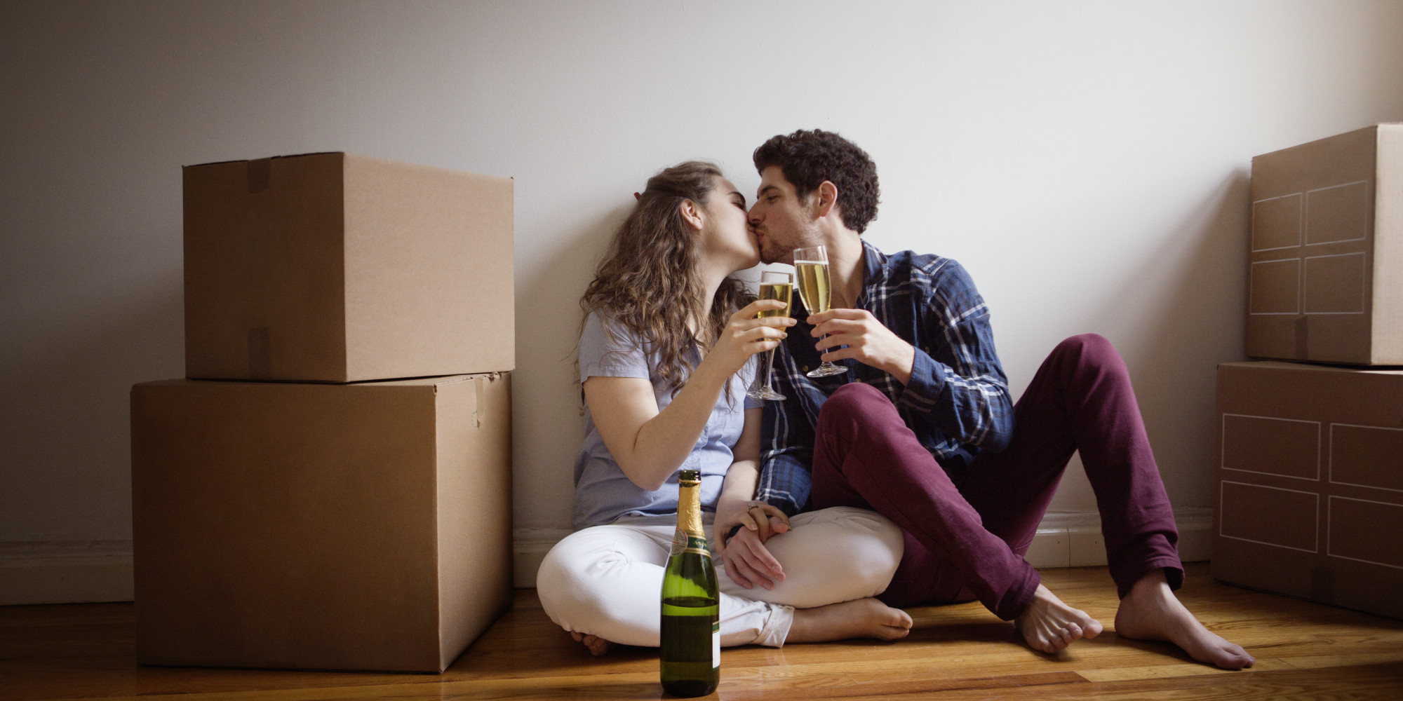 Couple Kissing And Toasting To Their New Home