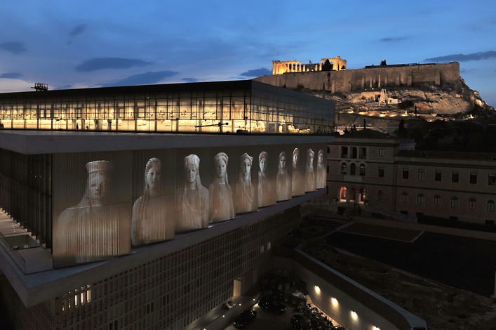 A projection depicting core-women statues is seen under the Parthenon hall on the new Acropolis museum building during the rehearsal of the opening ceremony on June 18, 2009. Designed by celebrated Franco-Swiss architect Bernard Tschumi, Greece's Acropolis Museum will finally be unveiled on June 20th, an ultra-modern glass building at the foot of the ancient citadel originally intended to be open in time for the 2004 Olympics. AFP PHOTO / Louisa Gouliamaki (Photo credit should read LOUISA GOULIAMAKI/AFP/Getty Images)
