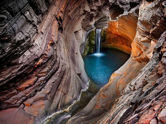 Karijini National Park in WA is one of the largest and most photogenic national parks in Australia. The park is famous for its sheer gorges, waterfalls, sparkling rock pools and cool swimming holes. Karijini is about 275km south of Port Hedland and 100km east of Tom or Paraburdoo. The park is all about exploring serpentine tunnels of marbled rock, clambering over boulders, squeezing through narrow tunnels, inching your way along ledges, paddling through subterranean waterways and descending deep into chasms which have been eroded into the landscape over two billion years.