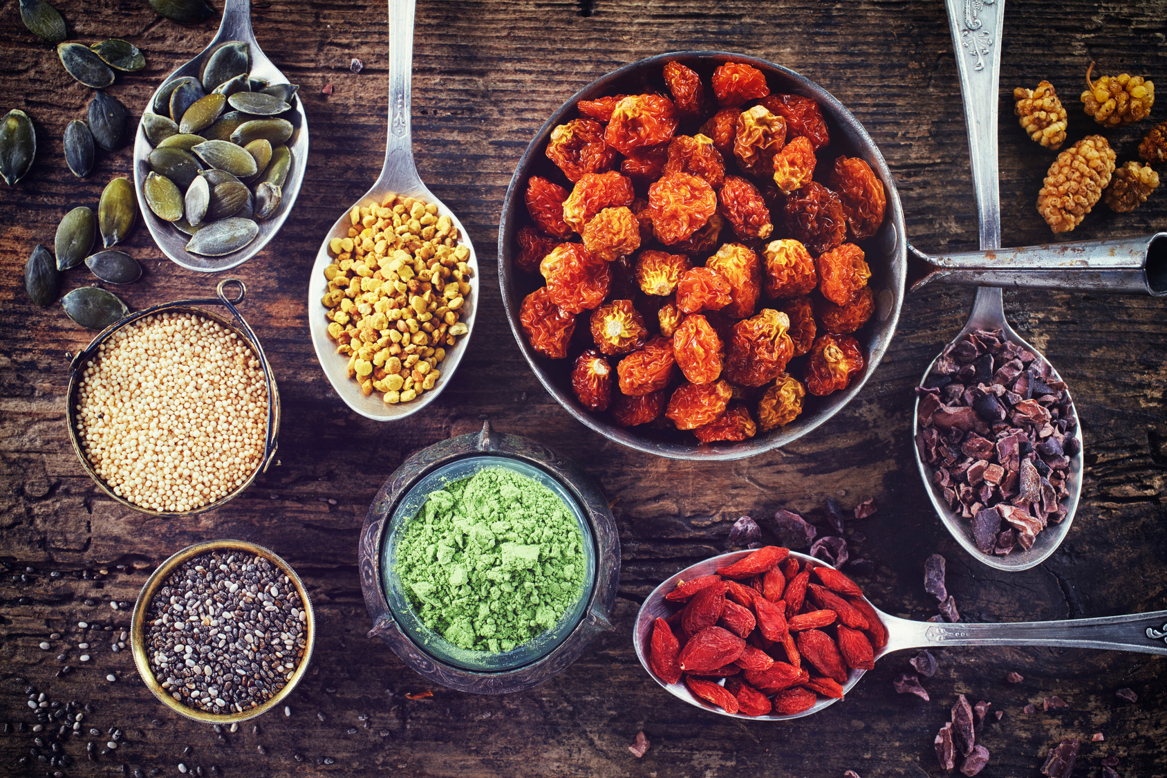 Various superfoods on wooden background