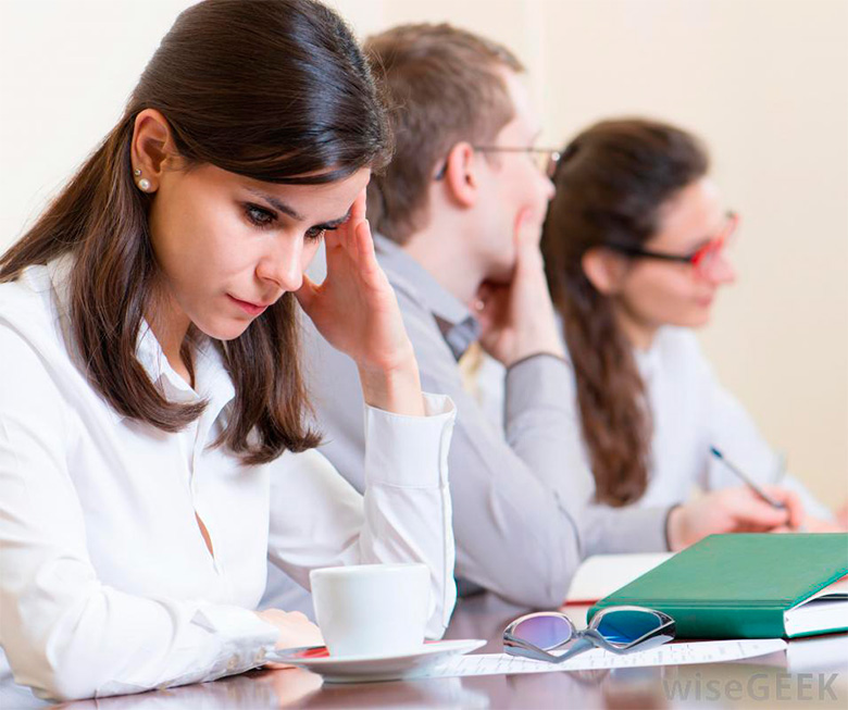 woman-in-white-at-meeting-with-hand-on-head