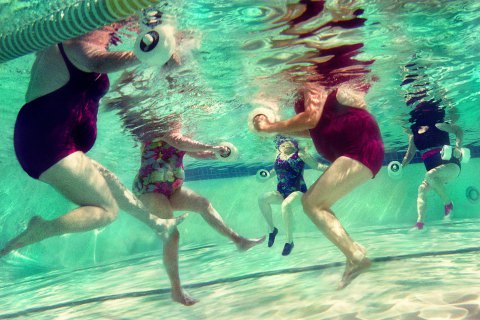 Mature women doing aqua aerobics, uderwater view (Digital Composite)