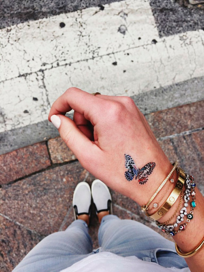 tatuaje de mariposa en la mano
