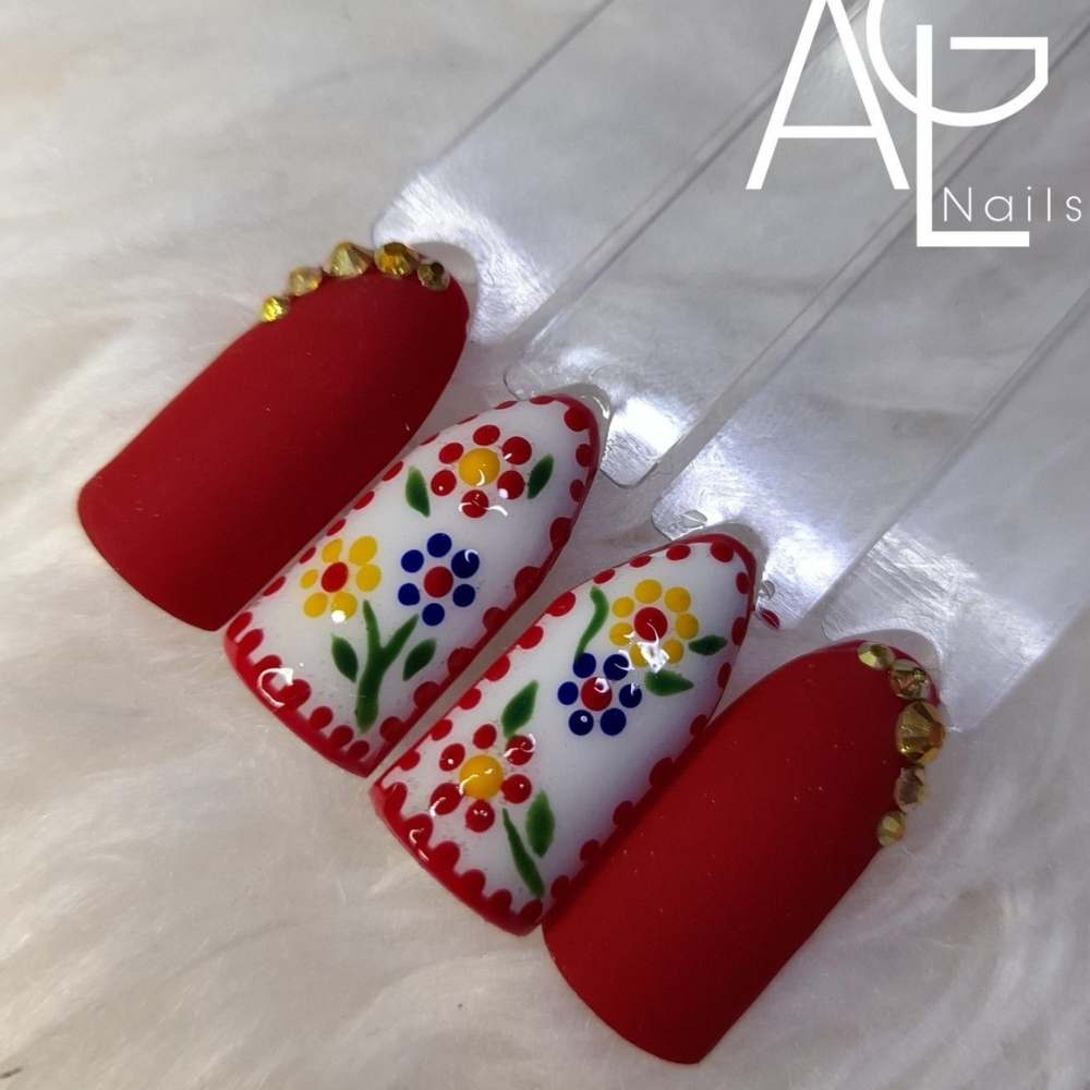 Muestrario de uñas rojas con blanco con diseño de bordado
