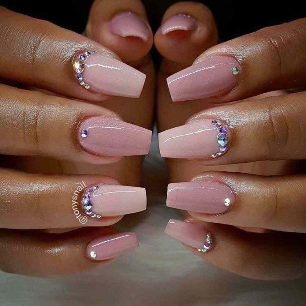 uñas rosa pastel con piedritas en cutícula