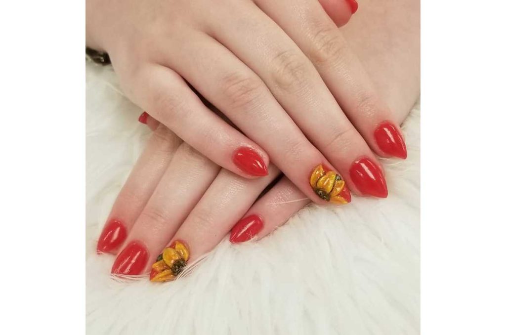 Uñas rojas 3d con girasoles