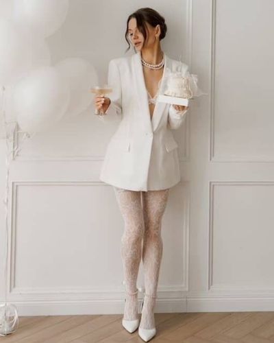 Foto de novia en fondo balnco. Tendencias en vestidos de novia: Inspiración sastre