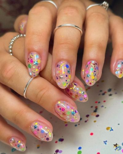 Manicura con base nude con destellos de colores